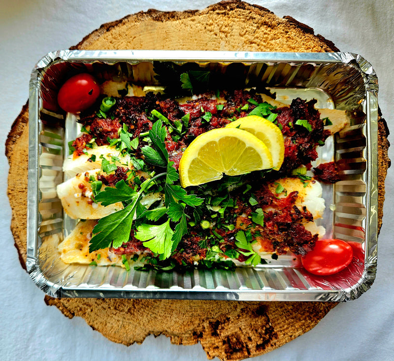 Roasted cod fillet, olive tapenade and dried tomatoes, bed of arugula